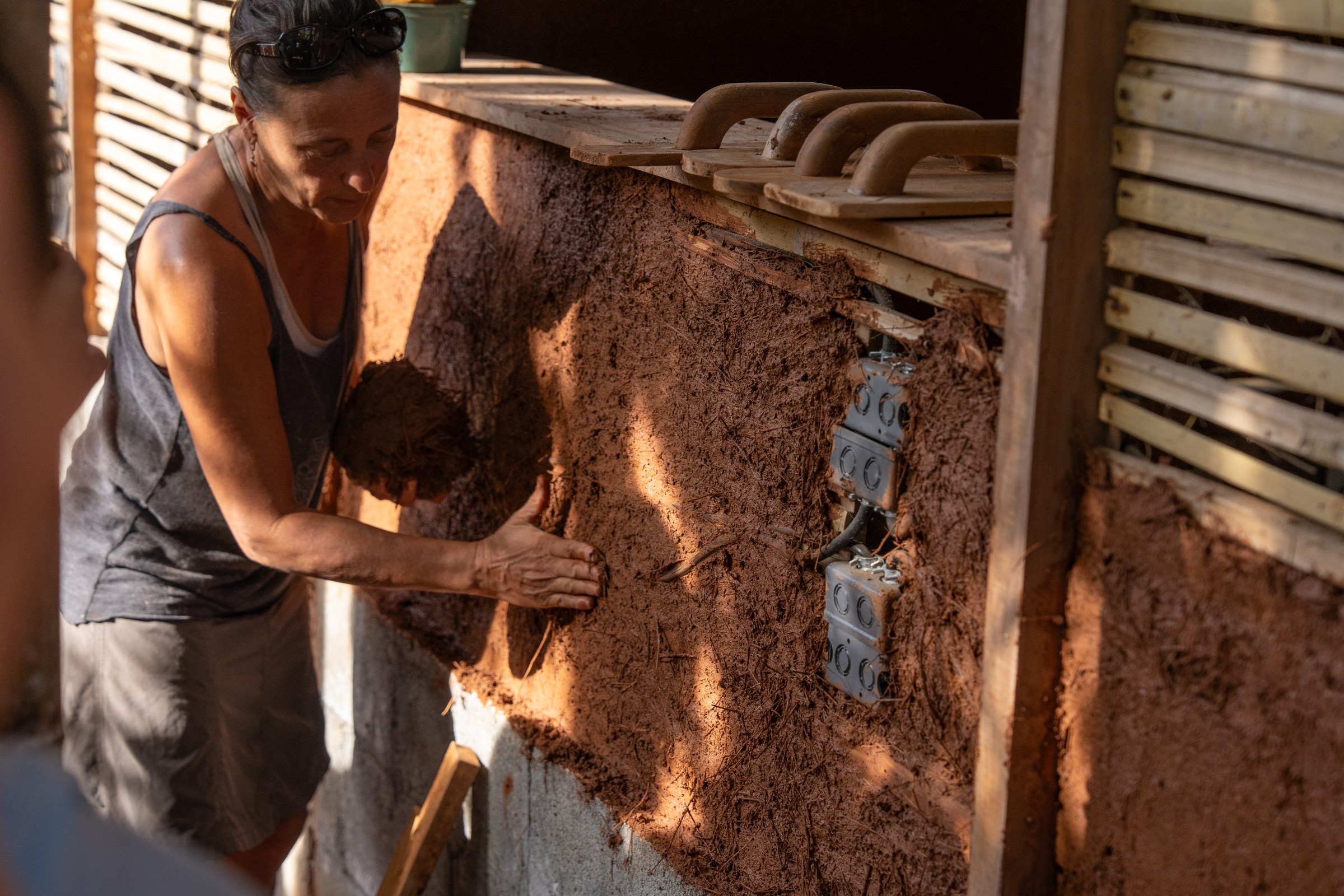 Earth plaster being applied to a wall assembly