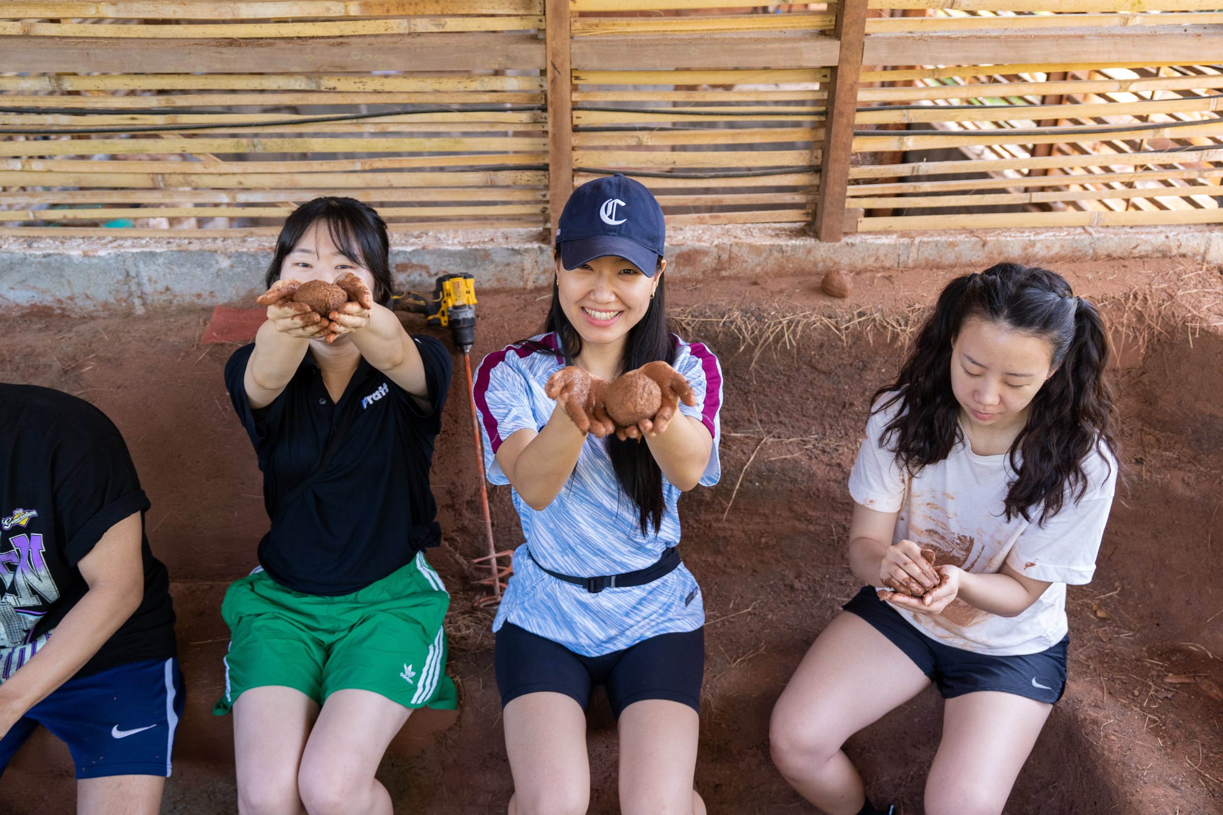Students examining hand-formed earth samples